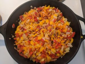  Onions, peppers, carrots, and mushrooms in a pan